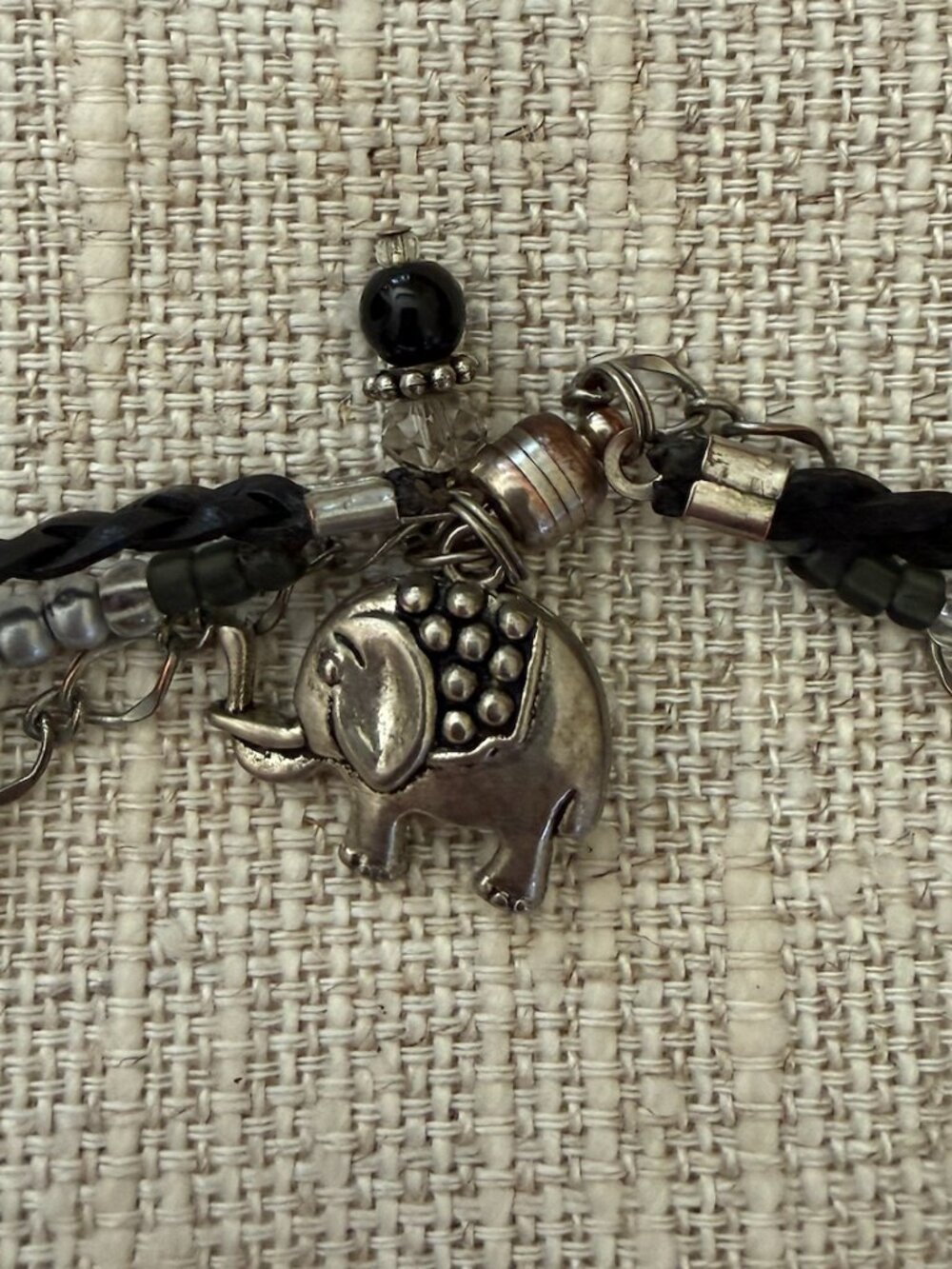 Silver wrap leather chair bracelet with elephant accent